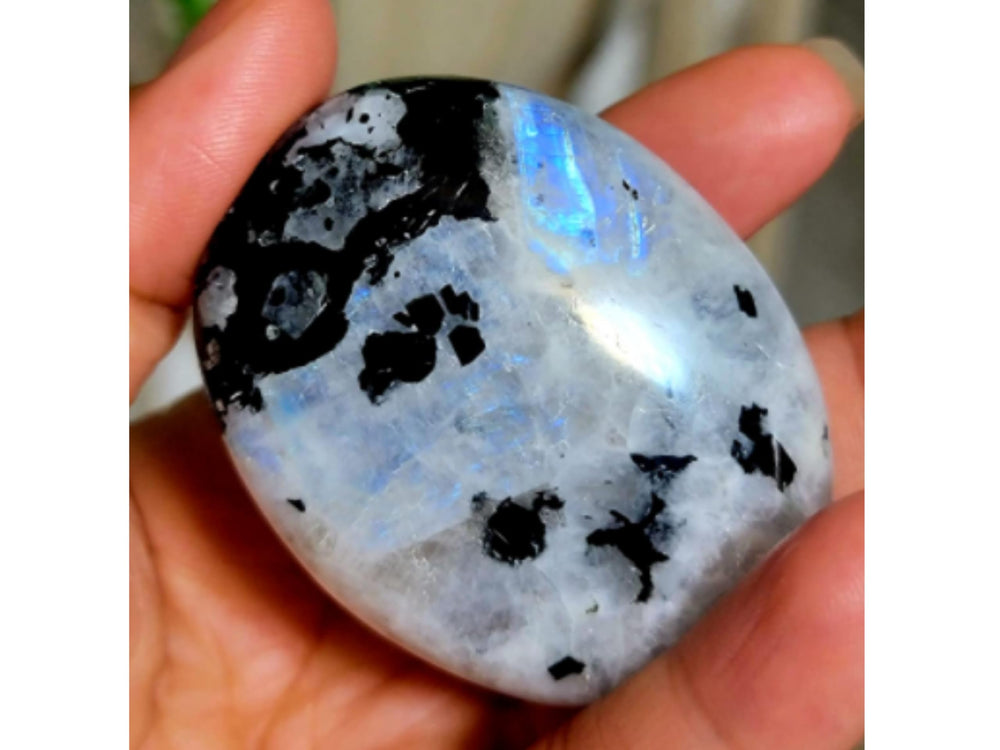 Amazing Gemstone Rainbow Moonstone palm stone styled as a calming mindfulness accessory