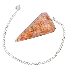 Hand holding the Amazing Gemstone Sunstone Orgone Pendulum showing natural organite texture.