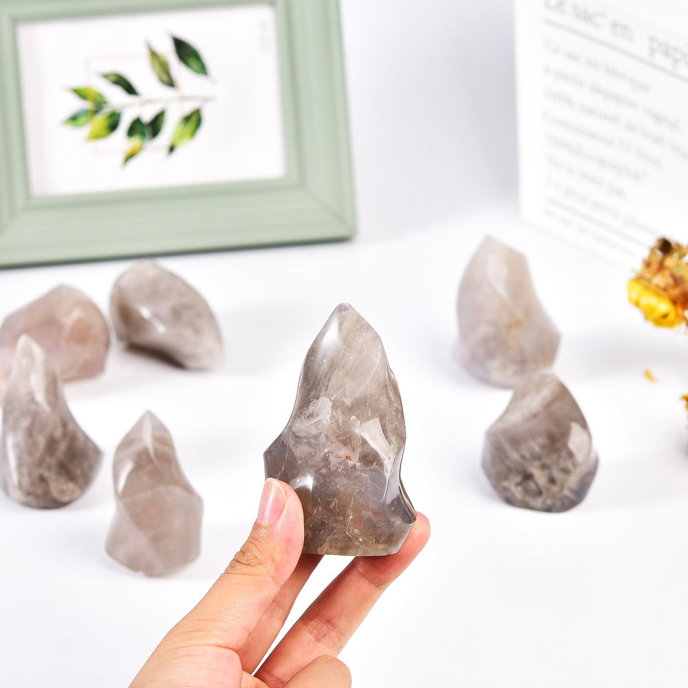 AMOYSTONE Blue Pink Quartz Flame Tower in a meditation setup for calm focus.