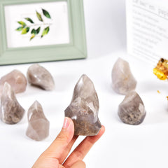 AMOYSTONE Blue Pink Quartz Flame Tower in a meditation setup for calm focus.
