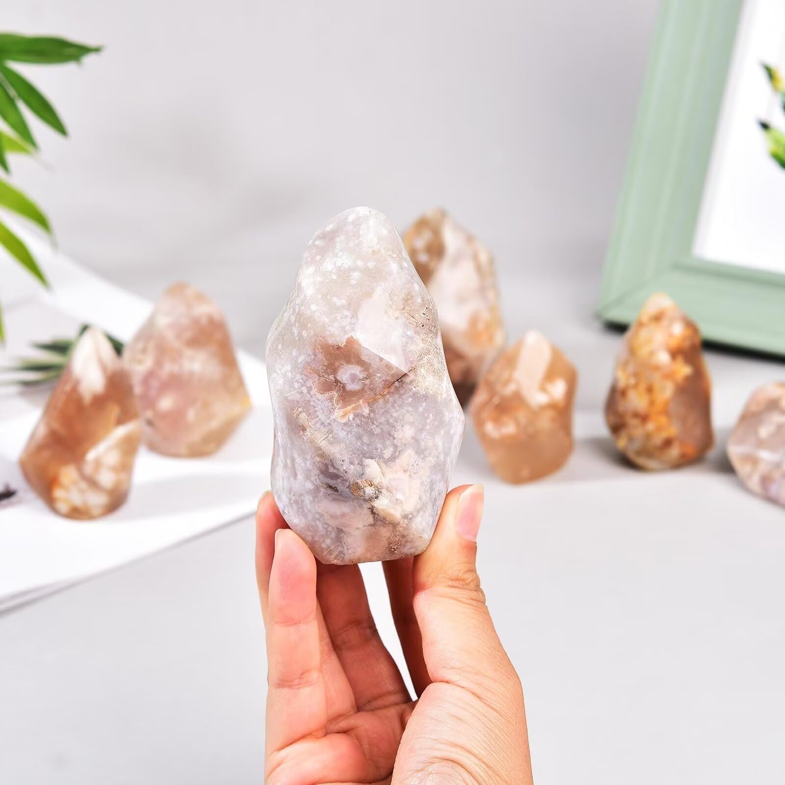 AMOYSTONE Cherry Blossom Agate flower obelisk showcases pink blooms on a stylish display.