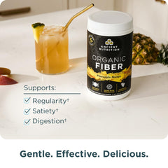 Ancient Nutrition Organic Fiber Powder glass dissolving into pineapple mango drink