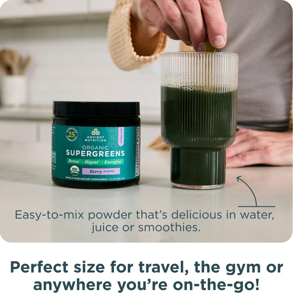 Ancient Nutrition SuperGreens powder dissolving glass demonstrates easy blending into smoothies.