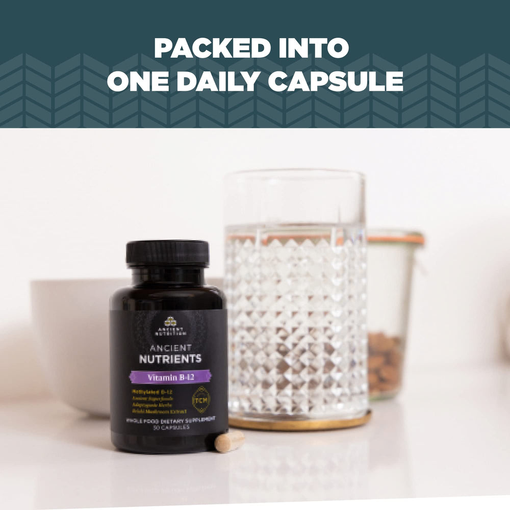 Ancient Nutrition Vitamin B12 bottle beside a glass of water for easy dosing.
