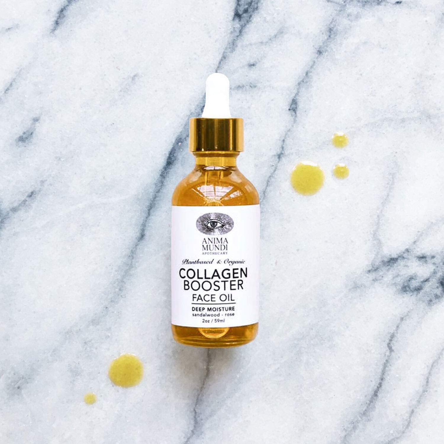 Anima Mundi Collagen Booster Oil dropper releasing silky oil