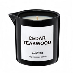 ANSOYER massage oil candle bottle in cedar-teakwood scent for skin hydration.