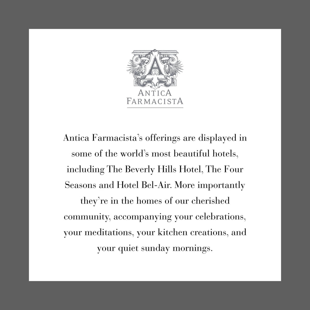 Antica Farmacista candle in a room setting with soothing glow.
