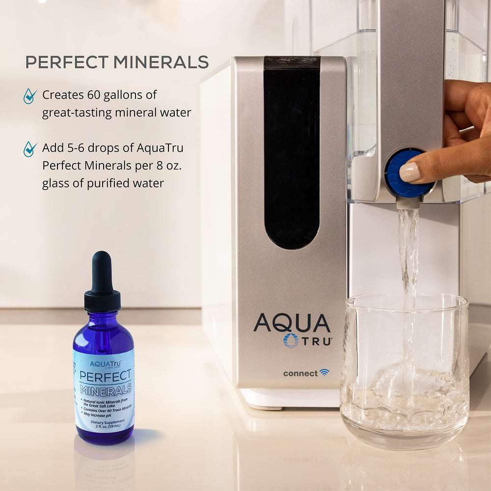 AquaTru Perfect Minerals in a glass of water ready to drink.
