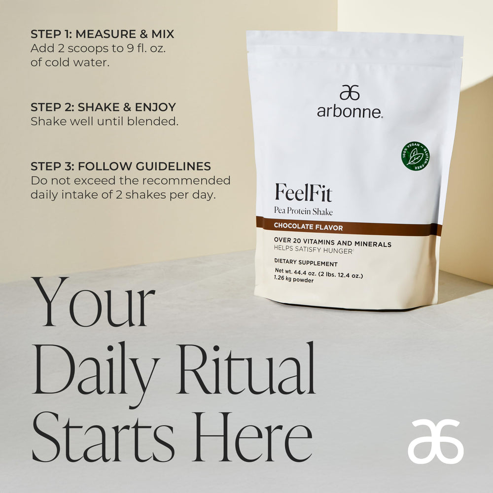 Arbonne Feelfit pea protein shake chocolate glass pour—smooth, dairy-free shake texture.