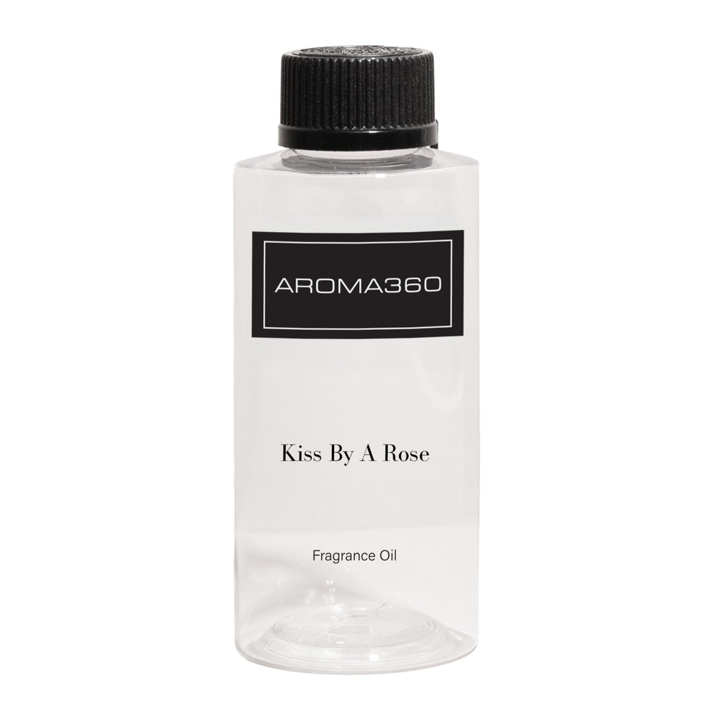 Aroma360 Kiss by a Rose bottle showcasing a luxurious fragrance in a premium setting.