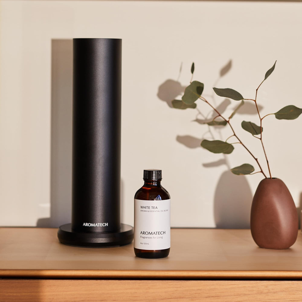 AromaTech White Tea amber bottle on a shelf, premium fragrance.