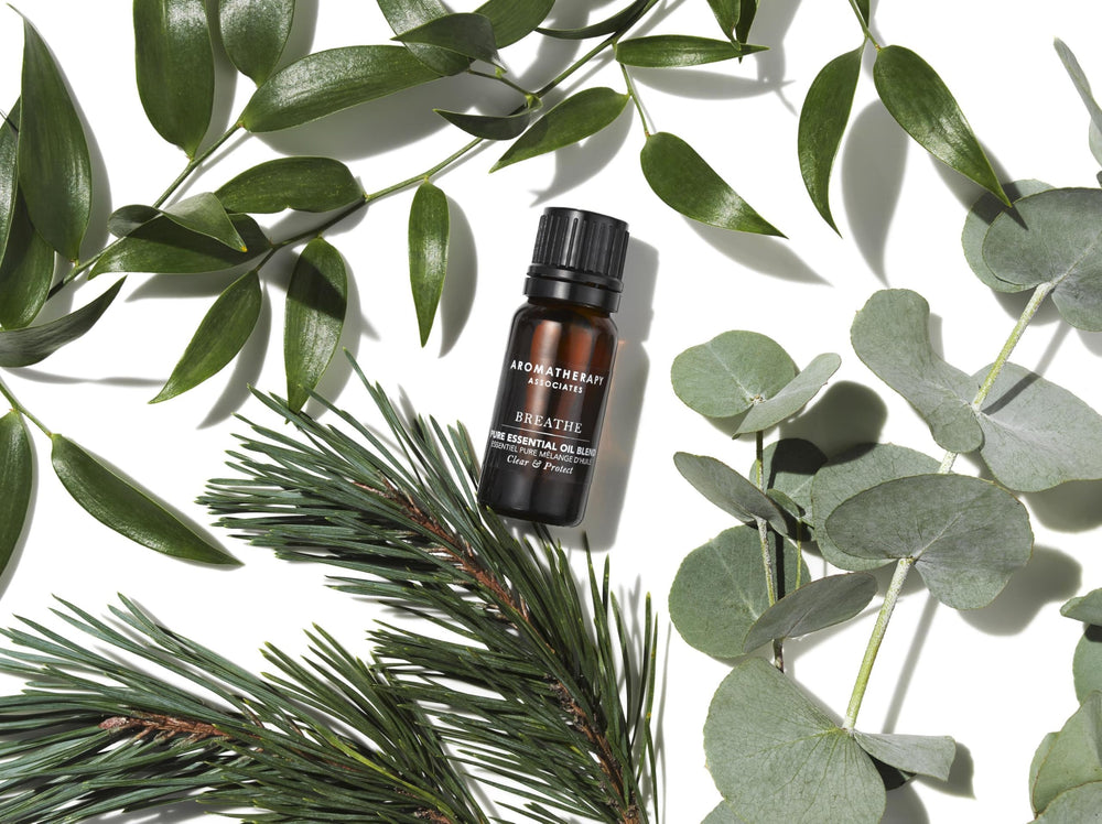 Aromatherapy Associates Breathe Pure with hands applying oil to wrists for a portable aroma