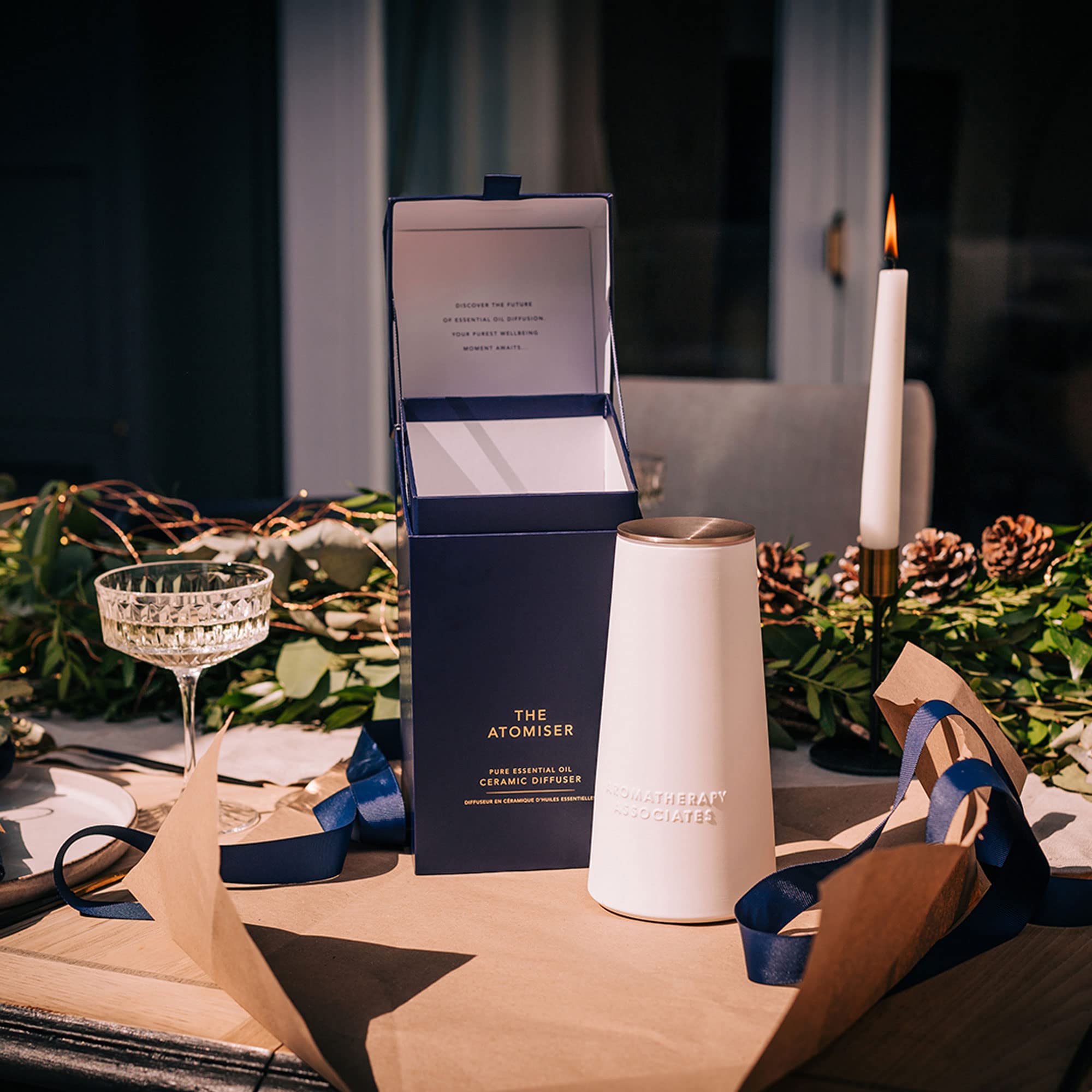 Aromatherapy Associates De-Stress blend bottle beside the diffuser during a quiet morning.