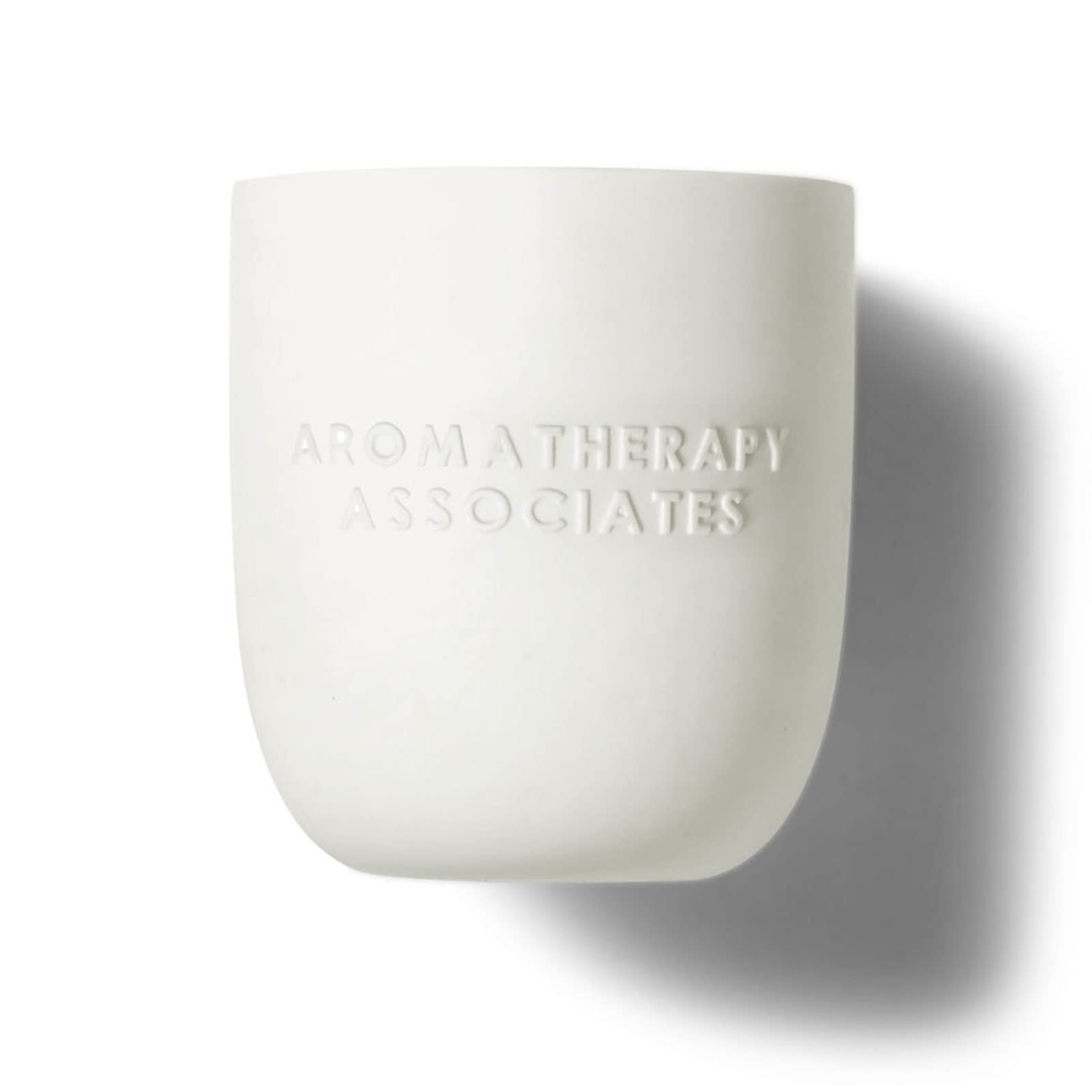 Aromatherapy Associates De-Stress Candle lit in a cozy room for focus.