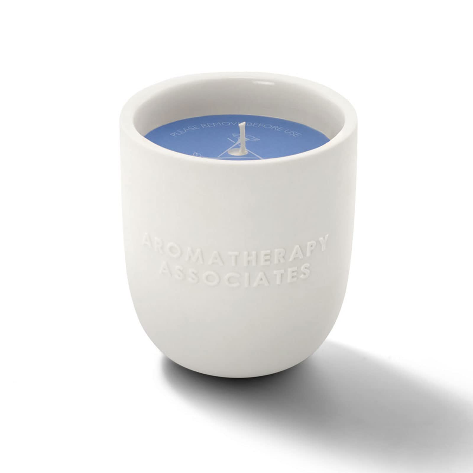 Close-up of the wick beside the ceramic holder shows premium design.