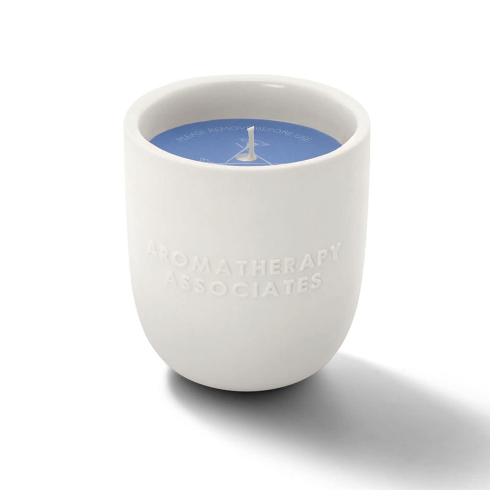 Close-up of the wick beside the ceramic holder shows premium design.