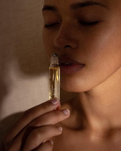 Aromatherapy Associates De-Stress Mind Rollerball in hand during a busy day.