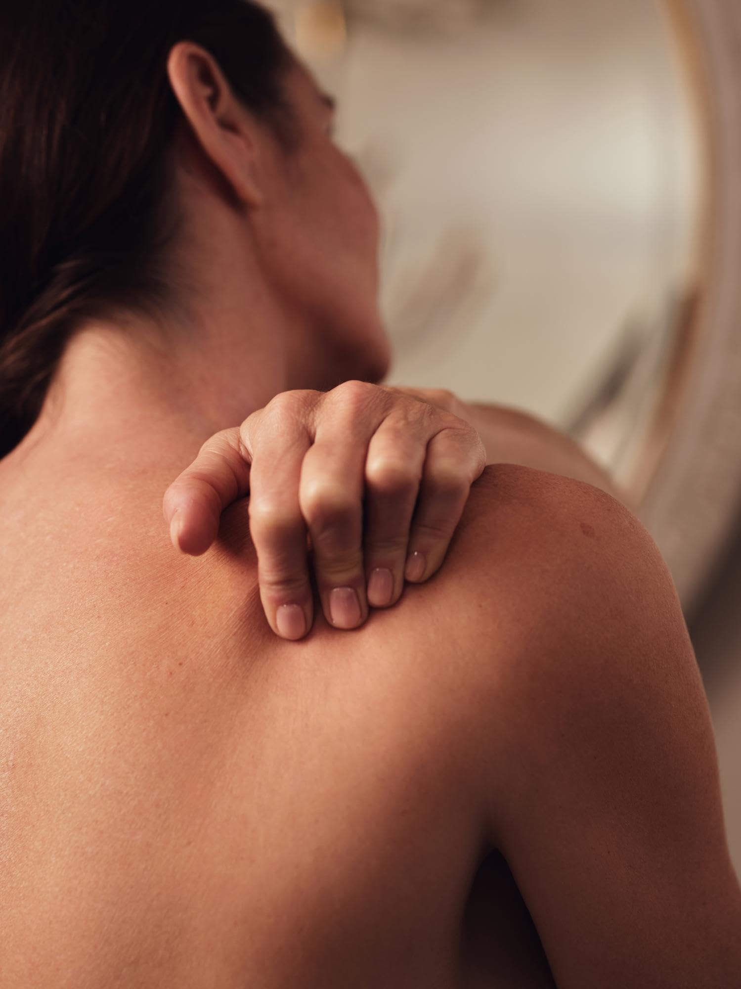 Aromatherapy Associates Revive bottle paired with carrier oil suggests a home blend.