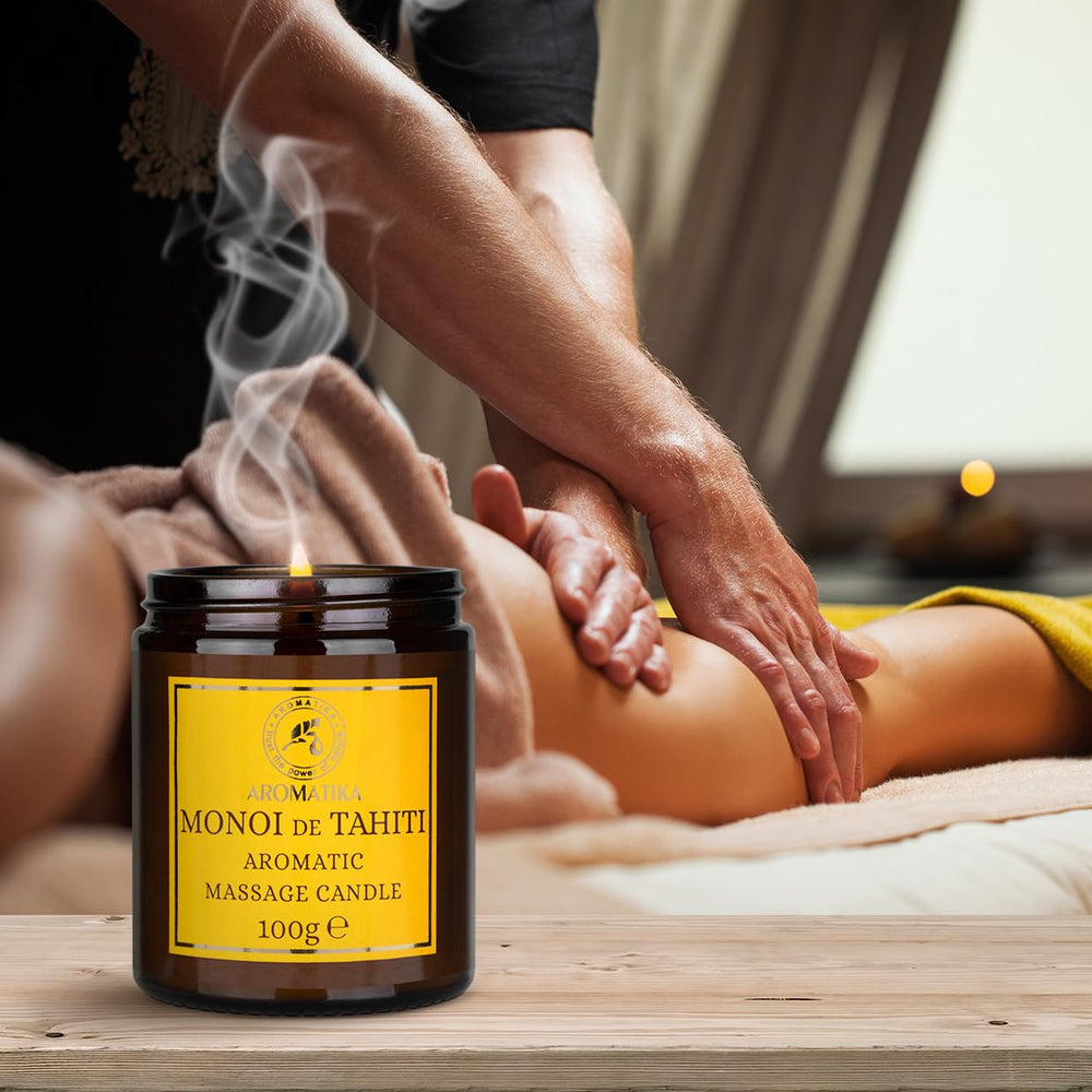 AROMATIKA Monoi Tahiti oils bottle beside candle evokes tropical relaxation.