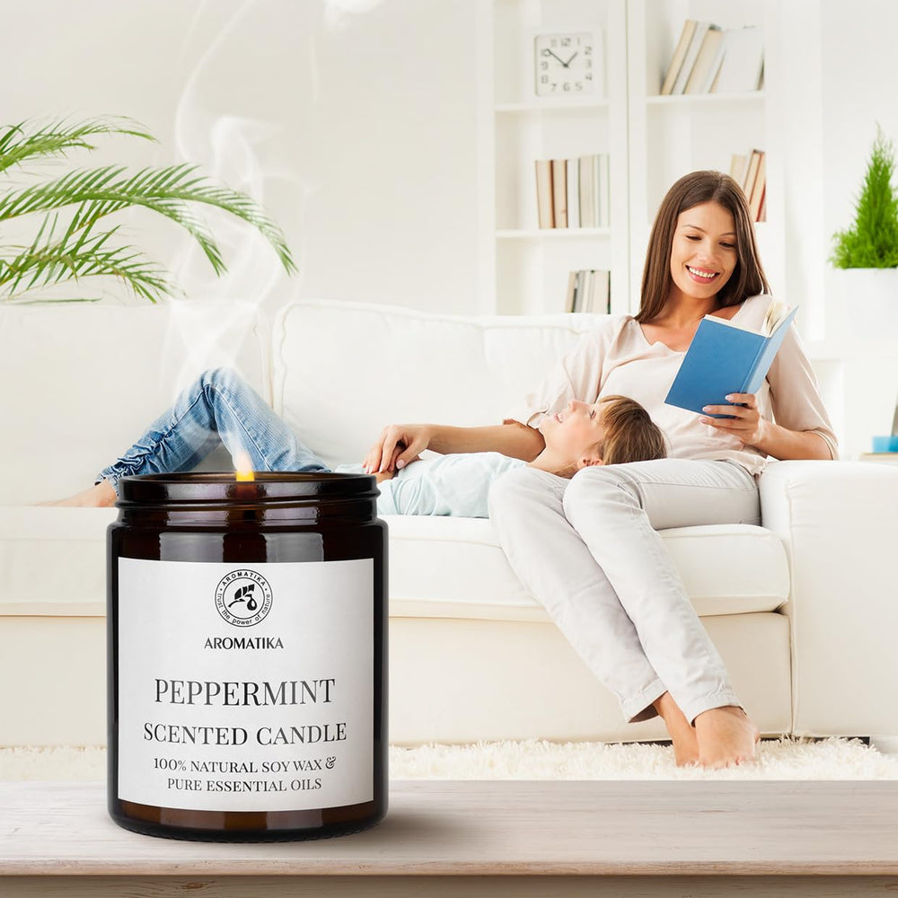 AROMATIKA peppermint candle glass jar detail, embossed logo visible.