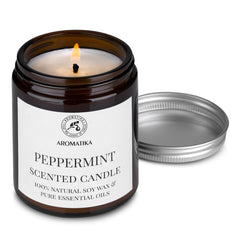 AROMATIKA peppermint candle lit on table, warm ambience and glow.