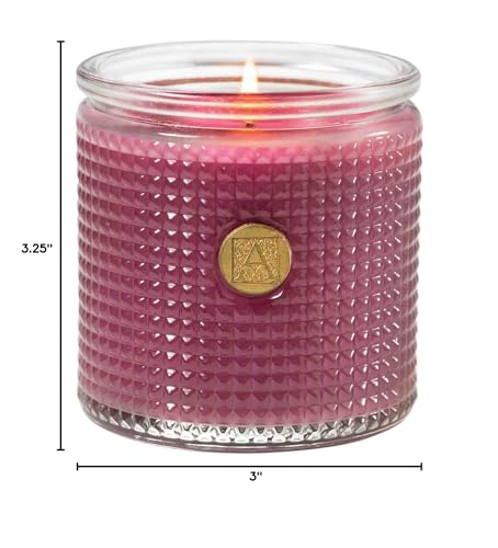 Aromatique Sparkling Currant candle in glass enhancing ambiance with floral warmth.
