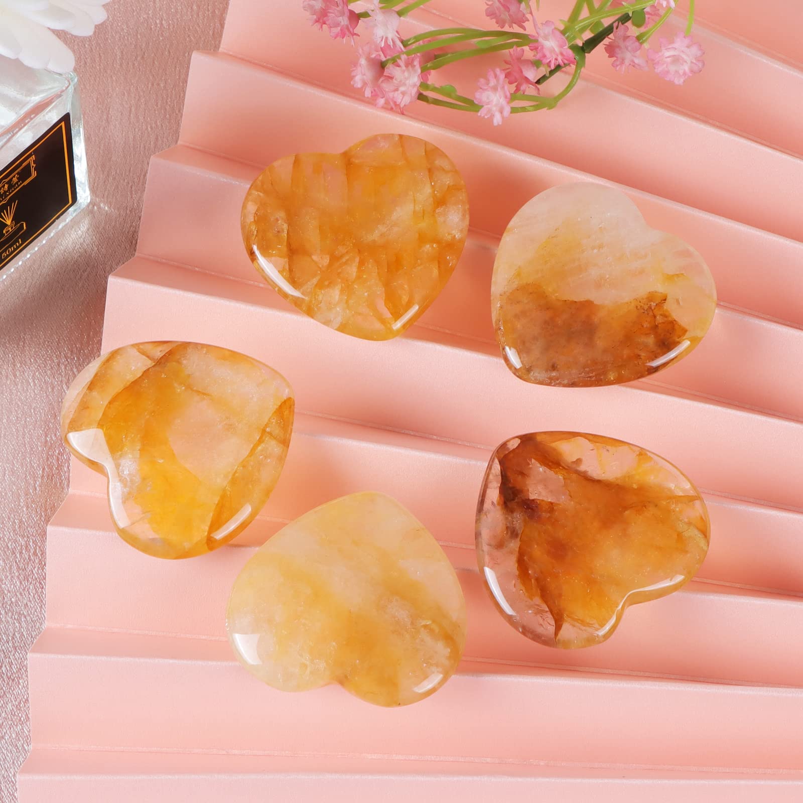 Artistone citrine heart thumb stone in hand for portable mindfulness