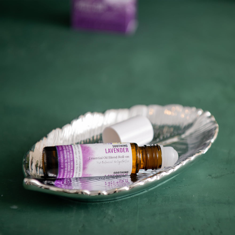 Aura Cacia Lavender Roll-On being applied to pulse points for quick calm.