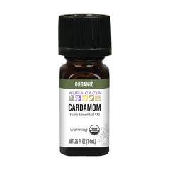 Aura Cacia Organic Cardamom Essential Oil bottle pour for massage and aromatherapy.
