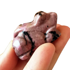 Bacatgem hand-carved rhodonite frog highlighting unique stone grain.