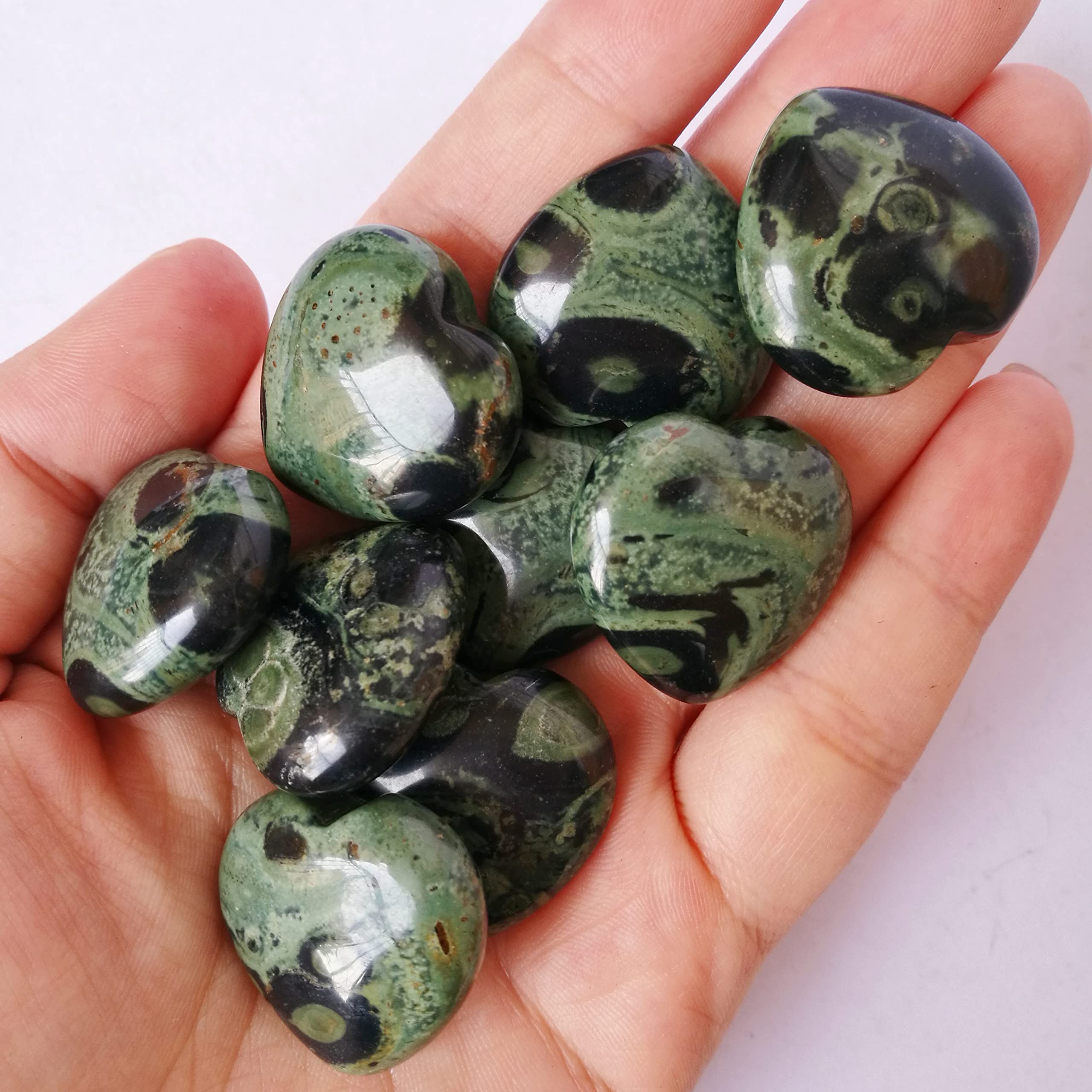 Bacatgem Kambaba Jasper palm stone held in hand for grounding
