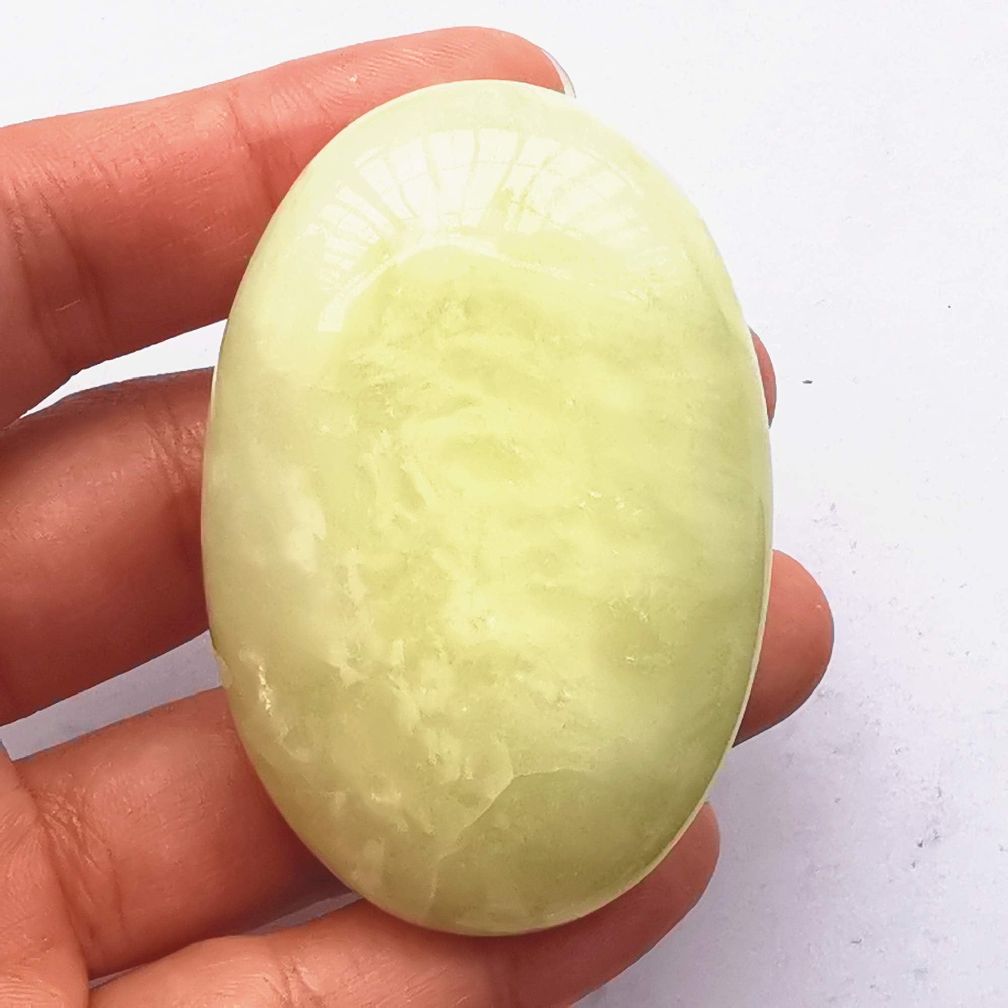 Bacatgem oval palm massage stone highlights calming energy during spa sessions.