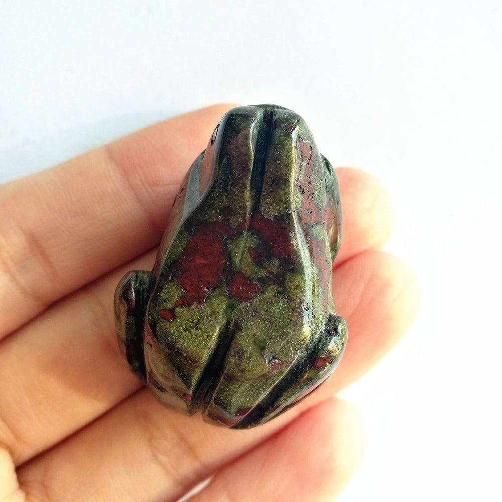 Bacatgem pocket-size frog gemstone decor beside a notebook