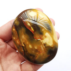 Bacatgem polished crystal healing stone closeup; smooth surface for palm massage.