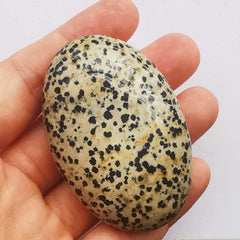 Bacatgem Speckle Dalmation worry stone in hand for meditation focus.