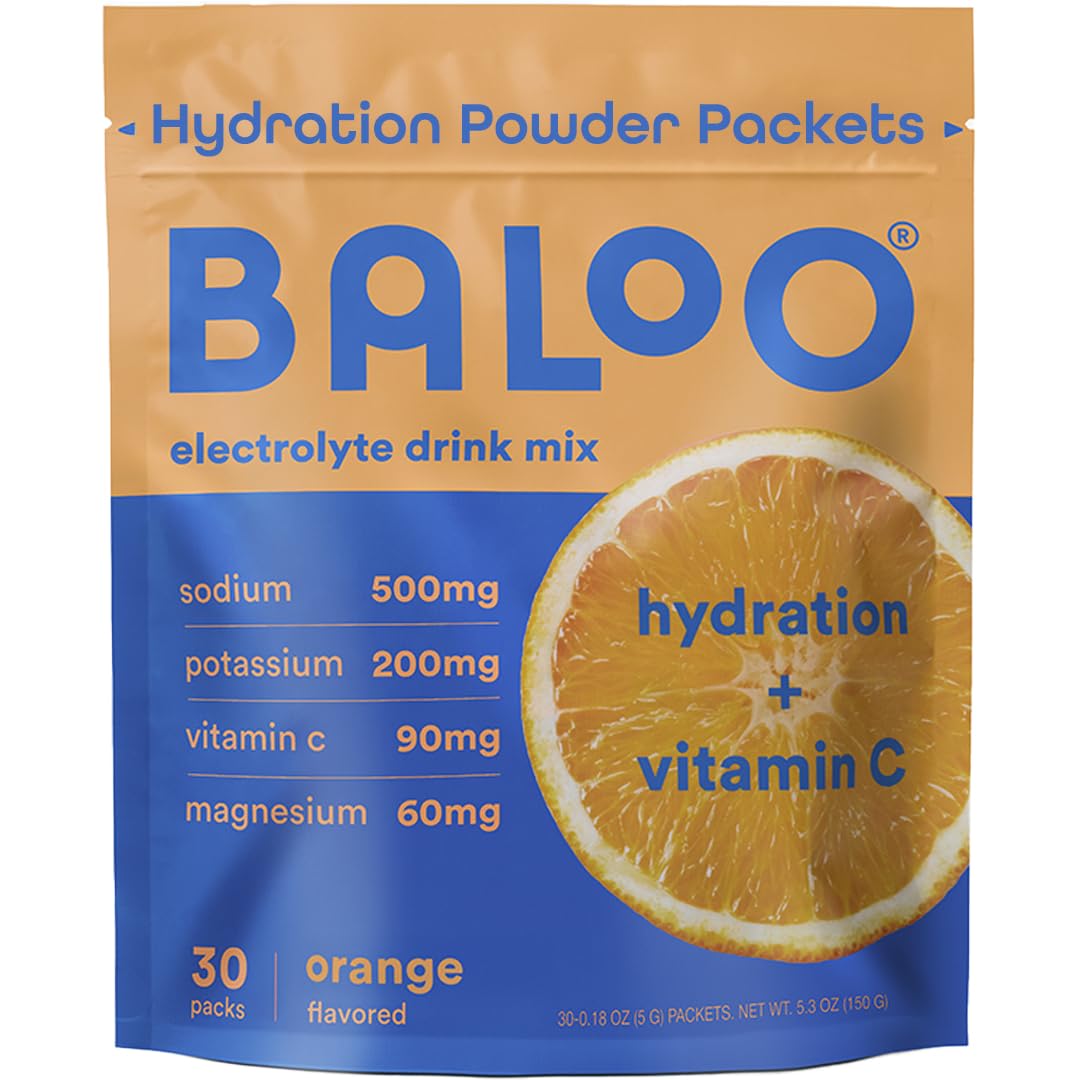 Baloo electrolytes orange packet beside a glass of water for refreshing hydration