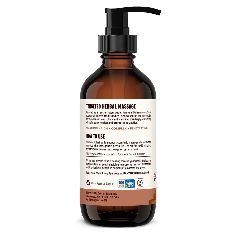 Banyan Mahanarayan Oil bottle with organic herb blend in focus.
