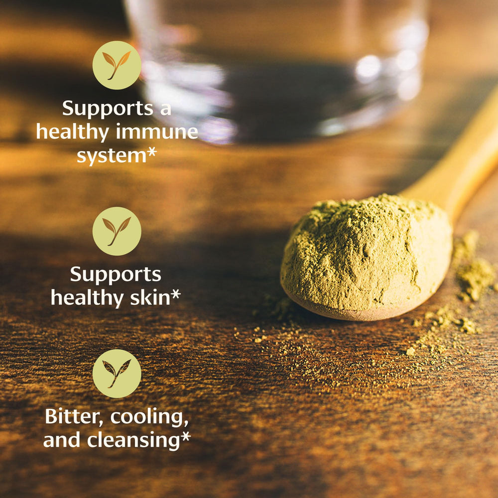 Hands blending Banyan Neem Powder into a facial mask for skincare