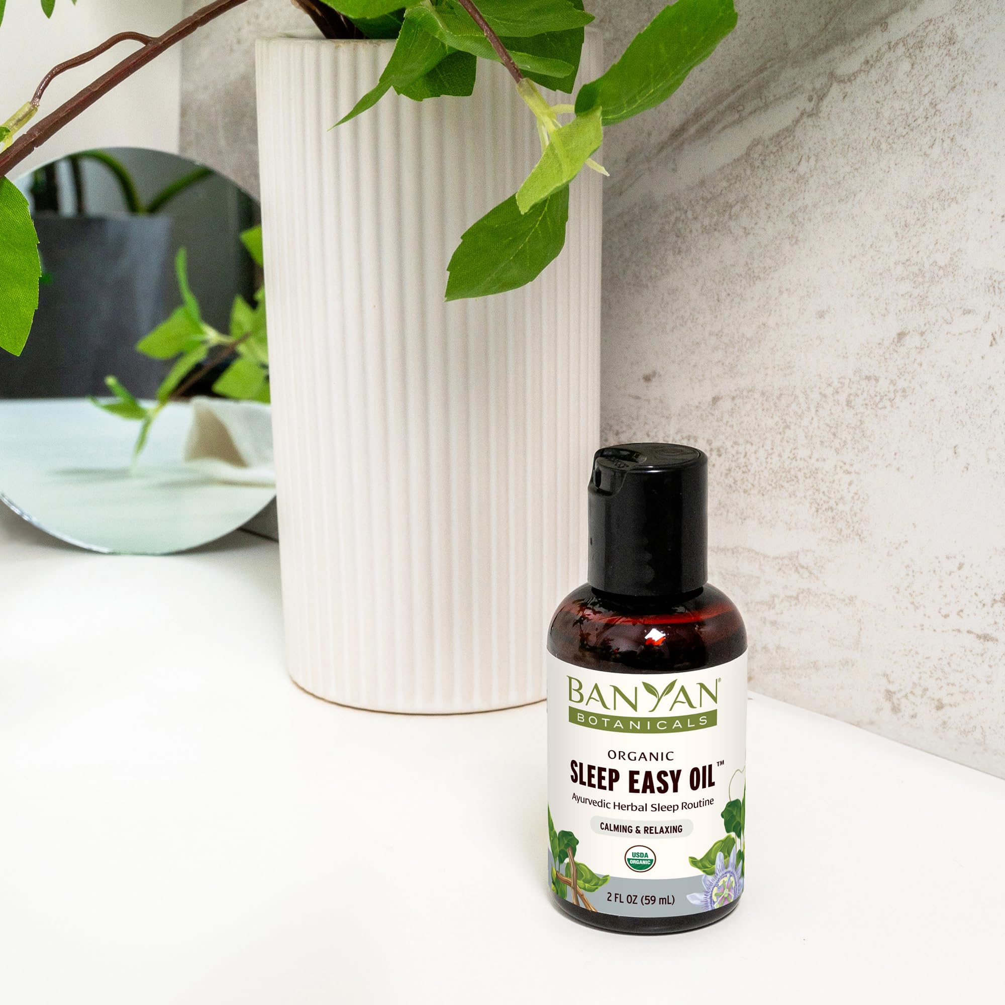 Banyan Botanicals Sleep Easy Oil packaging highlighting organic sourcing.