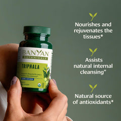 Banyan Botanicals Triphala tablets bottle closeup showing convenient daily supplement.