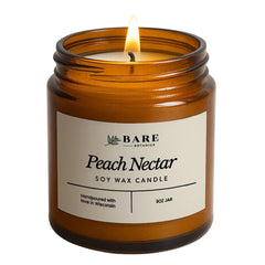 Bare Botanics Peach Nectar in an amber jar with a warm, cozy glow.
