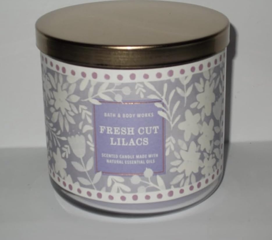 Bath & Body Works White Barn 3-Wick Candle close-up with three flames for cozy ambience.