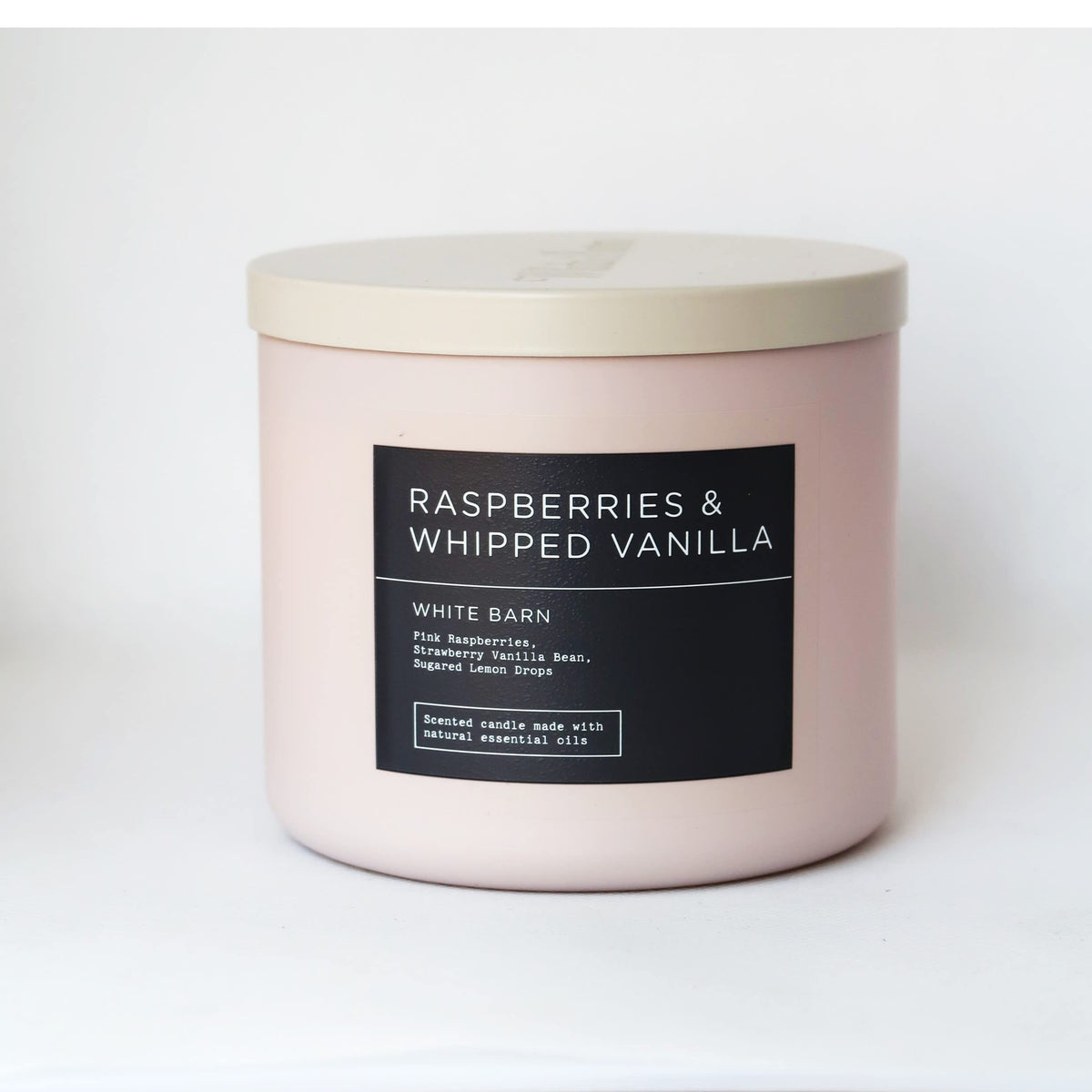 Bath & Body Works White Barn candle jar with raspberry and vanilla notes for cozy ambiance.