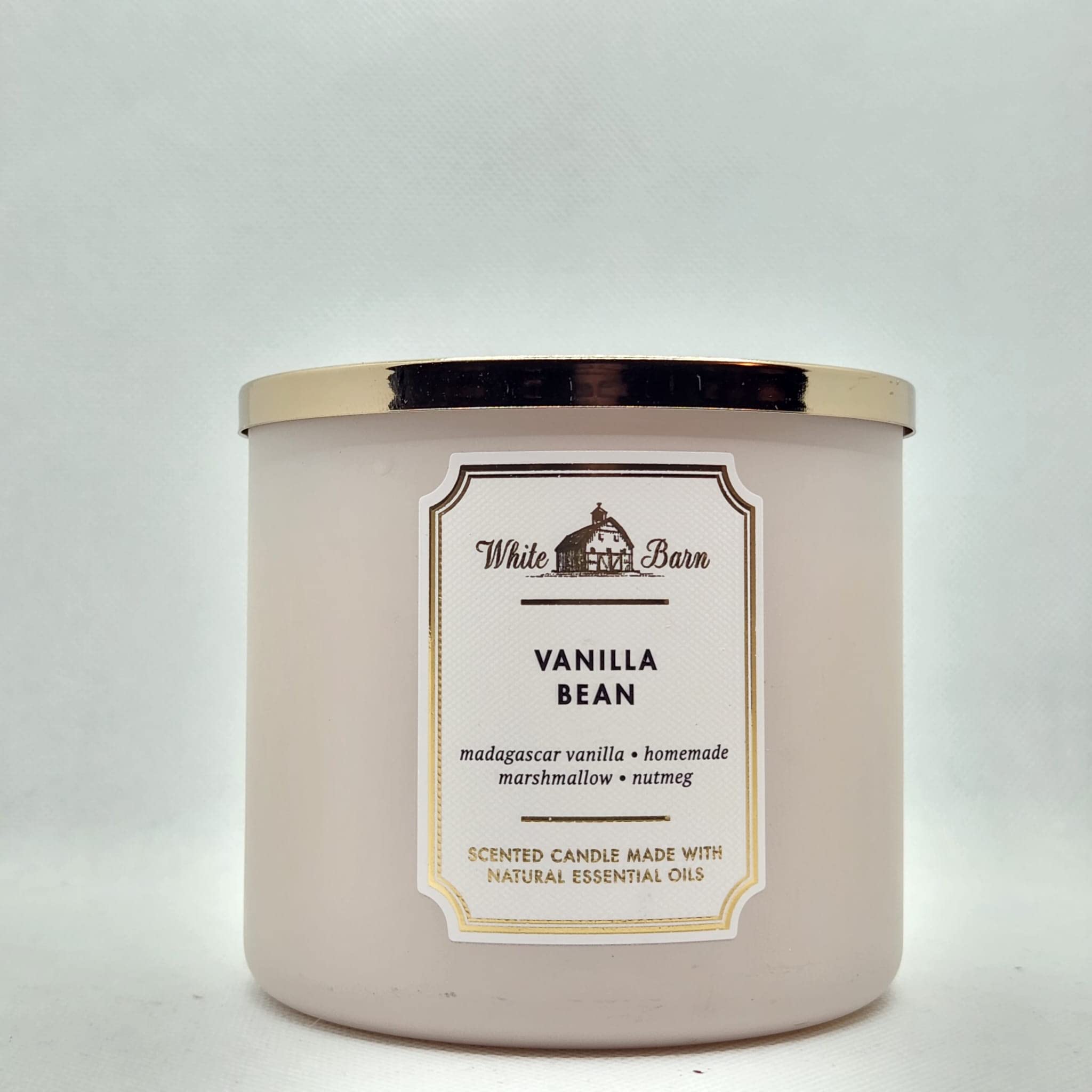 Bath & Body Works White Barn Vanilla Bean 3-Wick candle in a jar for cozy evenings.