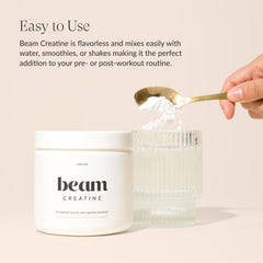 Beam Creatine Powder mixed beverage in glass shows easy dissolution for workouts.