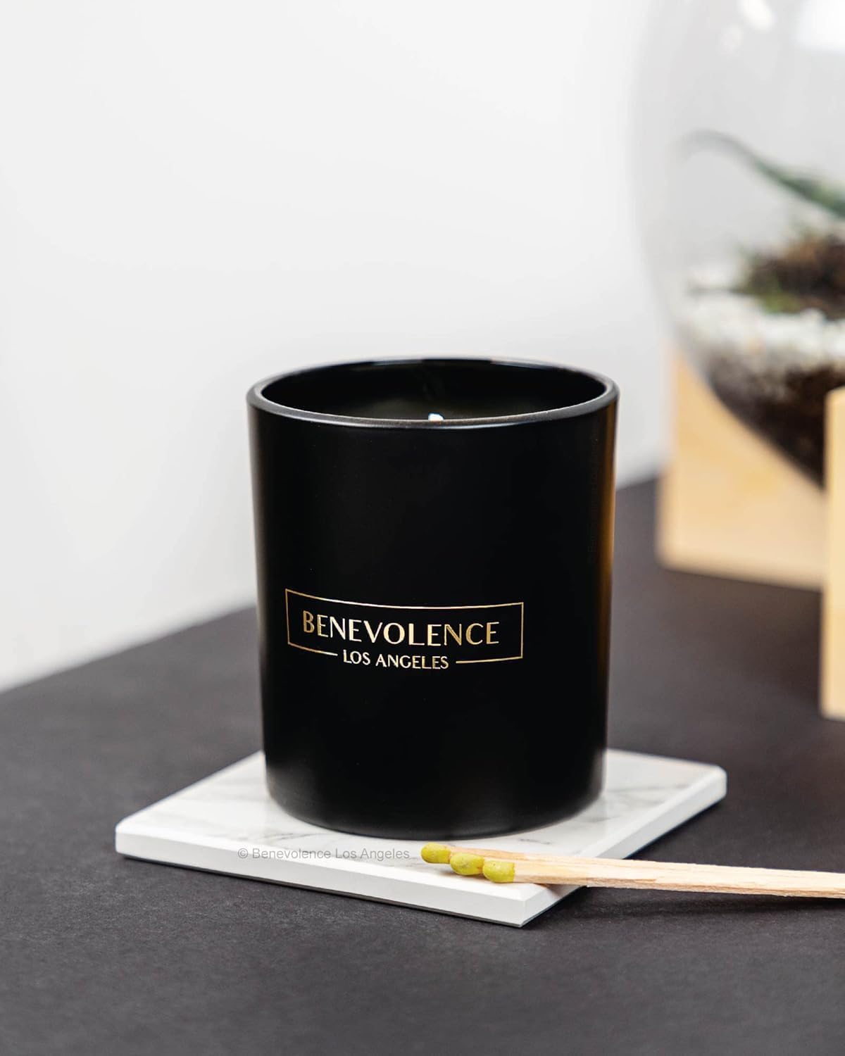 Benevolence LA Bergamot Jasmine candle on coffee table adds festive aromatics.