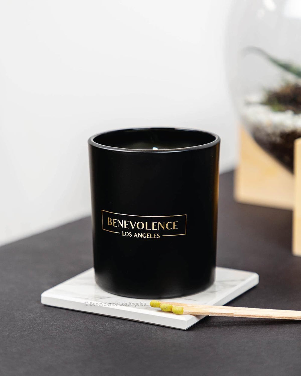 Benevolence LA Bergamot Jasmine candle on coffee table adds festive aromatics.