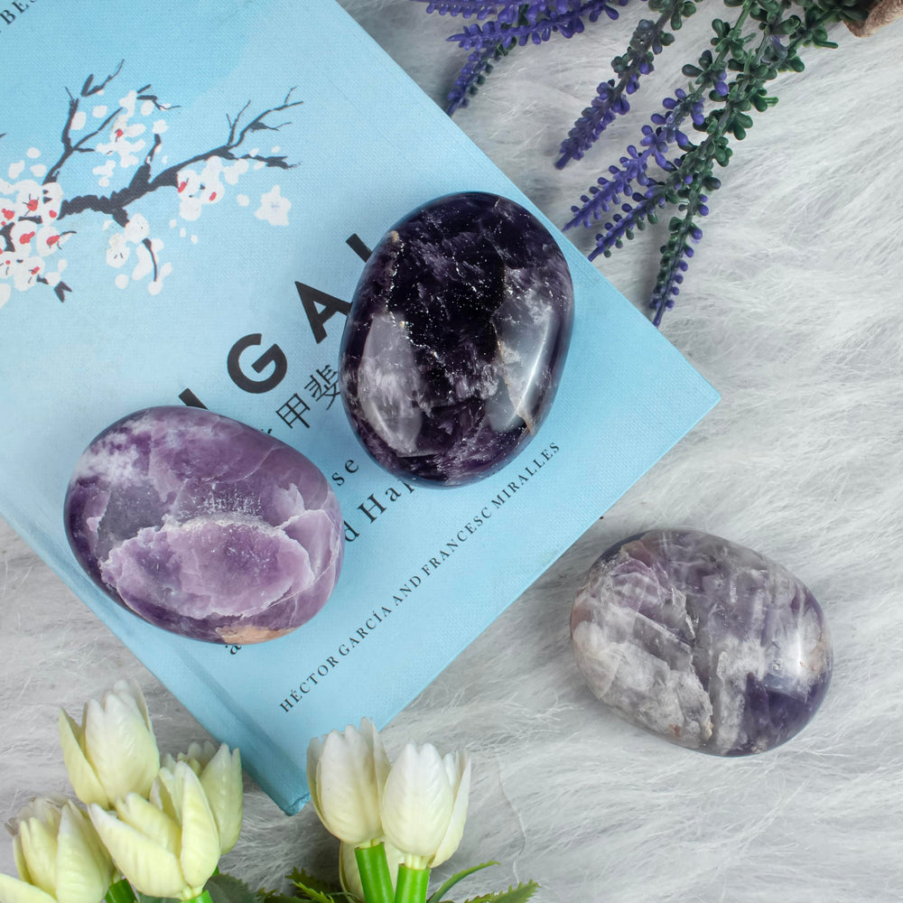 BEZAVO Amethyst Oval Palm Stone home decor piece with a subtle purple glow