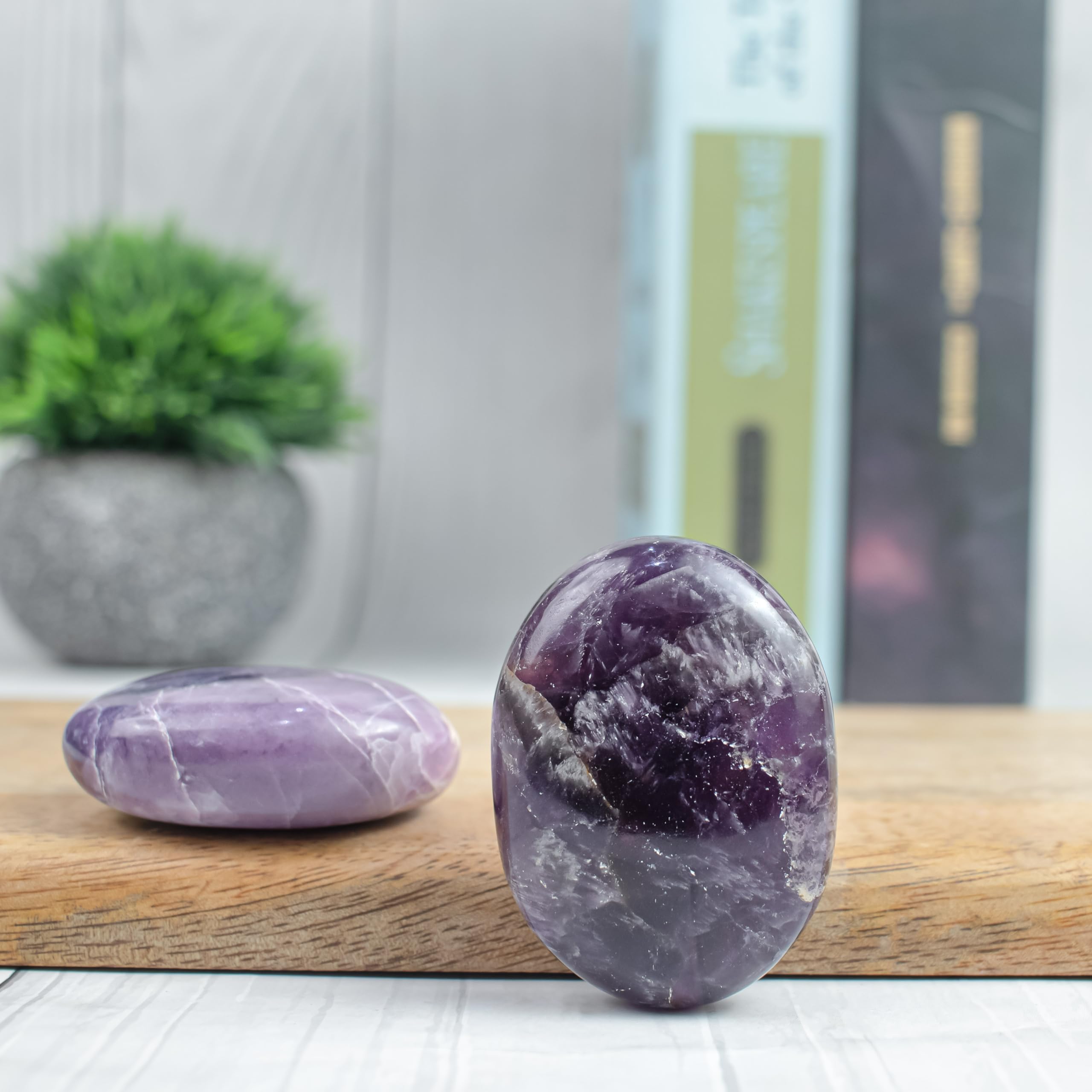 BEZAVO Amethyst Oval Palm Stone placed on a desk for mindful energy focus