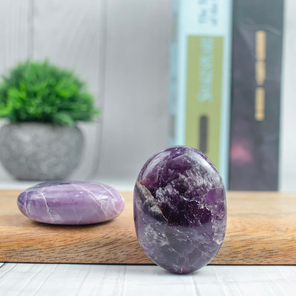 BEZAVO Amethyst Oval Palm Stone placed on a desk for mindful energy focus
